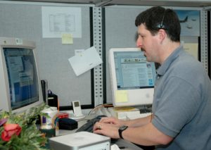 Man working a car sales deal on the computer