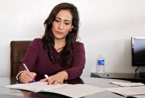 Finance manager filling out DMV paperwork